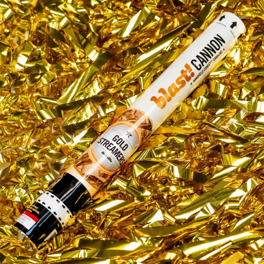 gold confetti cannon with gold ribbon background